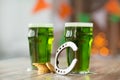 Glass of green beer, horseshoe and gold coins Royalty Free Stock Photo
