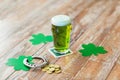 Glass of green beer, horseshoe and gold coins Royalty Free Stock Photo