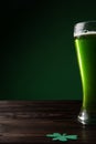 glass of green beer with shamrock on table st patricks Royalty Free Stock Photo