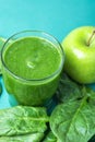 Glass with Green Fresh Smoothie from Leafy Greens Vegetables Fruits Bananas Kiwi Cucumber. Scattered Spinach Leaves Apple Royalty Free Stock Photo