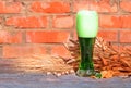 Glass of green Irish beer standing on an old table