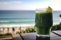 glass of green juice, with view of the ocean, for a health boost on vacation