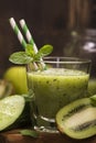 Glass of green refreshing smoothie with kiwi, cucumber and apple Royalty Free Stock Photo