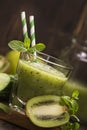 Glass of green refreshing smoothie with kiwi, cucumber and apple Royalty Free Stock Photo