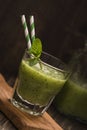 Glass of green refreshing smoothie with kiwi, cucumber and apple Royalty Free Stock Photo