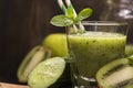 Glass of green refreshing smoothie with kiwi, cucumber and apple Royalty Free Stock Photo