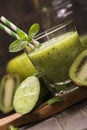 Glass of green refreshing smoothie with kiwi, cucumber and apple Royalty Free Stock Photo