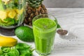 Glass of green smoothie with fresh juicy fruits, spinach, avocado, chia seeds and blender for making healthy detox drink Royalty Free Stock Photo