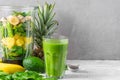 Glass of green smoothie with fresh juicy fruits, spinach, avocado, chia seeds and blender for making healthy detox drink Royalty Free Stock Photo