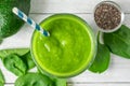 Glass of green smoothie made of spinach and avocado with fresh fruits and chia seeds on white background. Healthy diet Royalty Free Stock Photo