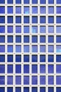 Glass blue square Windows of facade modern city business building skyscraper. Modern apartment buildings in new neighborhood. Royalty Free Stock Photo