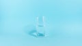 The glass is half empty or full. A glass transparent glass is filled with water. The concept of an optimistic and pessimistic Royalty Free Stock Photo