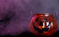 Glass halloween pumpkin candle holder with smoke