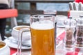 A glass of Hallstatt local beer on the table at a romantic restaurant beside the Hallstattersee Lake in High Alps Mountains, a Royalty Free Stock Photo