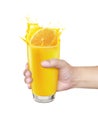 Glass of in hand orange juice splash. isolated on white background Royalty Free Stock Photo