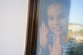 Through glass. happy teen girl look out of window outside. recovered. Royalty Free Stock Photo