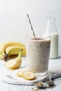 Glass of healthy banana and seeds smoothie