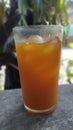 A glass of herbal drink made from turmeric and lotto plus a little sugar. In Indonesia it is known as jamu.