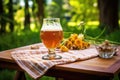 glass of homebrew beer on a picnic table