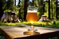 glass of homebrew beer on a picnic table