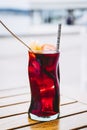 Glass of homemade sangria cocktail with fruits and ice cubes