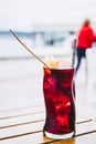 Glass of homemade sangria cocktail with fruits and ice cubes