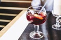 Glass of homemade sangria cocktail with fruits and ice cubes