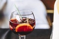 Glass of homemade sangria cocktail with fruits and ice cubes