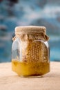 Glass honey jar with bee pollen, honeycombs
