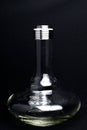 Glass hookah Flask with water drops on a black background.