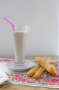 A glass of horchata accompanied by typical Valencian sweets