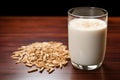 glass of horchata with rice grains in foreground