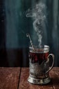 A glass of hot black tea in a vintage cup holder. Wonderful still life. Selective focus. The glass is opposite the window Royalty Free Stock Photo