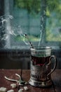 A glass of hot black tea in a vintage cup holder. Wonderful still life. Selective focus. The glass is opposite the window Royalty Free Stock Photo