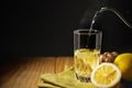 Glass of Hot Infusion Ginger lemon drink. Organic and Healthy Lifestyle. Fresh Water with lemon Sliced. present on Table with Royalty Free Stock Photo