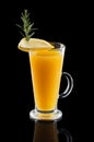 Glass of hot lemon tea with ginger and rosemary isoalted on black