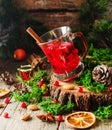 Glass of hot mulled wine for the new year with ingredients for cooking, nuts and Christmas decorations Royalty Free Stock Photo