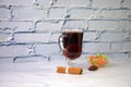 A glass of hot mulled wine with a slice of orange, cinnamon sticks, anise and a cup of dried fruit Royalty Free Stock Photo