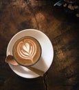 Glass of hot Piccolo coffee on the wooden table