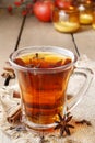 Glass of hot steaming tea among christmas decorations