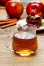 Glass of hot steaming tea on hessian napkin