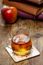 Glass of hot steaming tea on wooden tabl