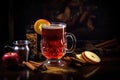 Glass of hot wassail or christmas winter punsh with spices and citrus on the dark background