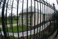 Glass house behind bars Royalty Free Stock Photo