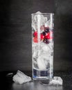 Glass of ice with berry gooseberries red black currants and water. Refreshing cocktail. Summer drink. Royalty Free Stock Photo