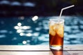 A glass of ice cola at pool with vintage filter background