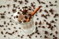 A glass of ice cream with coffee decorated of cinnamon sticks, coffee beans and star of anise