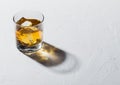 Glass with ice cubes of single malt whiskey on white background Royalty Free Stock Photo