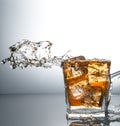 Glass with ice and liquid splash Royalty Free Stock Photo