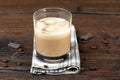 Glass with ice in original Irish cream liqueur, coffee beans and chocolate pieces. Royalty Free Stock Photo